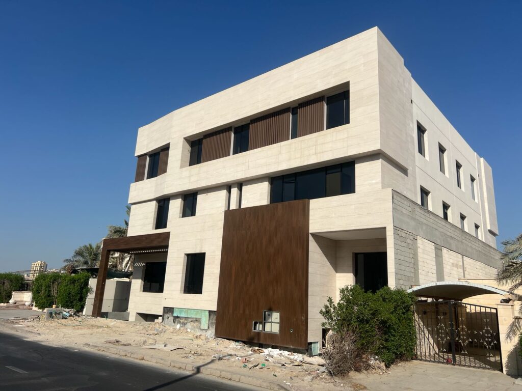 Modern house exterior combining Moca Cream limestone and wood